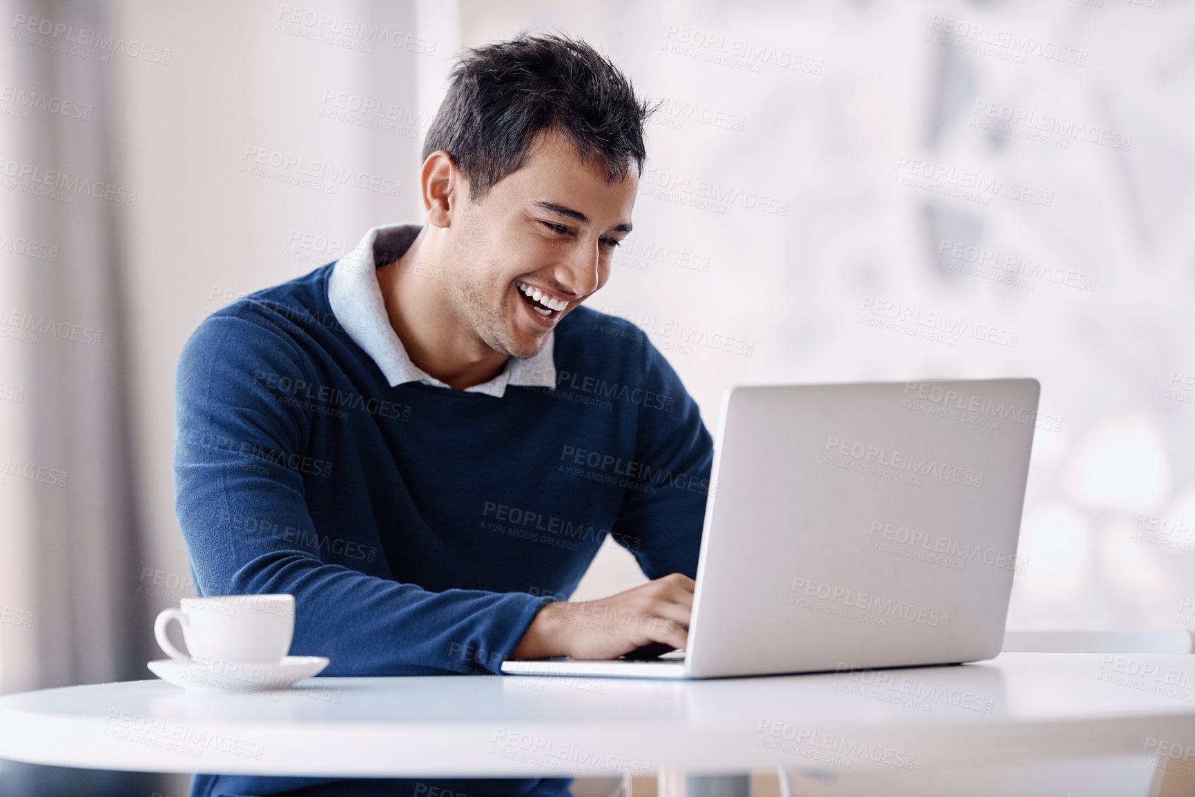 Buy stock photo Cropped shot of a handsome young businessman working on his laptop in the office