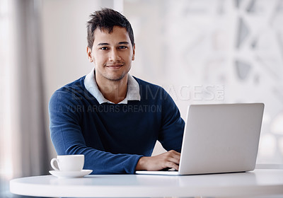 Buy stock photo Cropped portrait of a handsome young businessman working on his laptop in the office