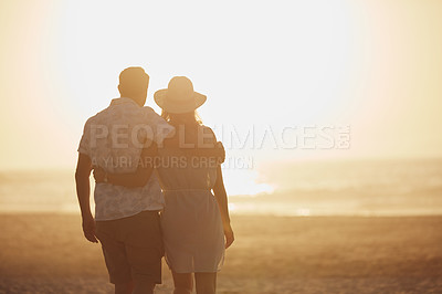 Buy stock photo Rearview shot of a mature couple spending quality time on the beach