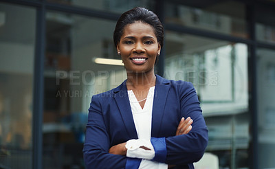 Buy stock photo Portrait of an attractive young businesswoman posing with her arms folded outdoors in the city