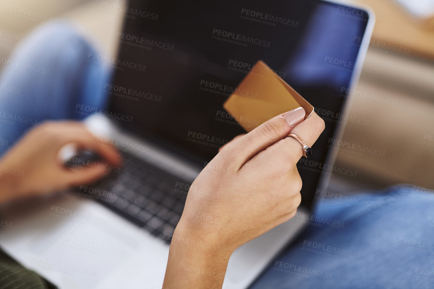 Buy stock photo Shot of an unrecognizable woman using a laptop and credit card to do some online shopping at home