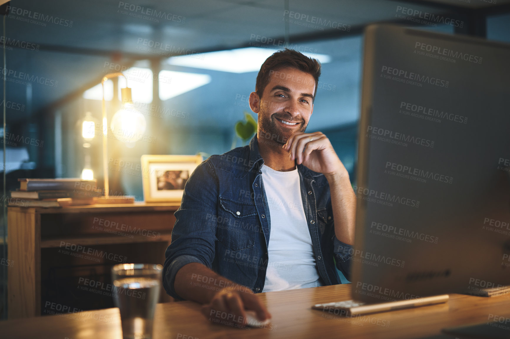 Buy stock photo Computer, happy and man in office at night for software development and data analytics of system. Portrait, technology and male IT specialist working overtime with online firewall configuration.