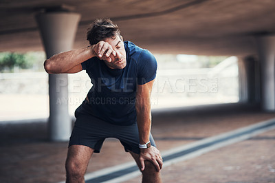 Buy stock photo Fitness, tired and man with sweat in outdoor for running challenge, exhausted or marathon training. Breathing, sports and male athlete with break for workout fatigue, cardio exercise or resting