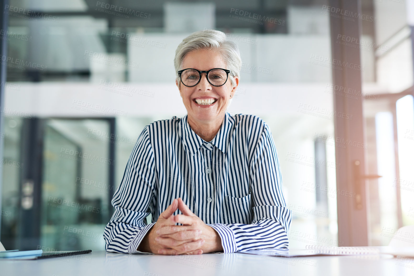 Buy stock photo Portrait of an attractive mature businesswoman sitting at her office desk at work