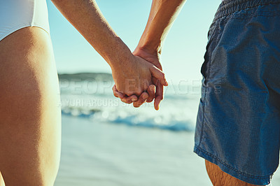 Buy stock photo Closeup shot of a couple holding hands at the beach