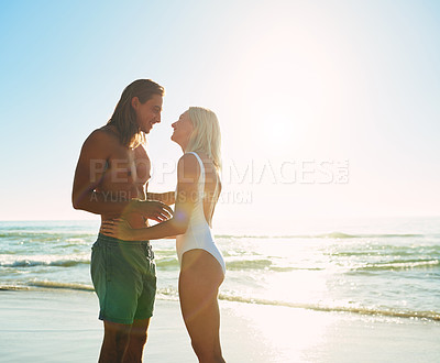 Buy stock photo Couple, happy and swimsuit with sunset on beach for tropical holiday, adventure and romance with mockup space. People, love and embrace at ocean with bonding, affection and relationship with smile