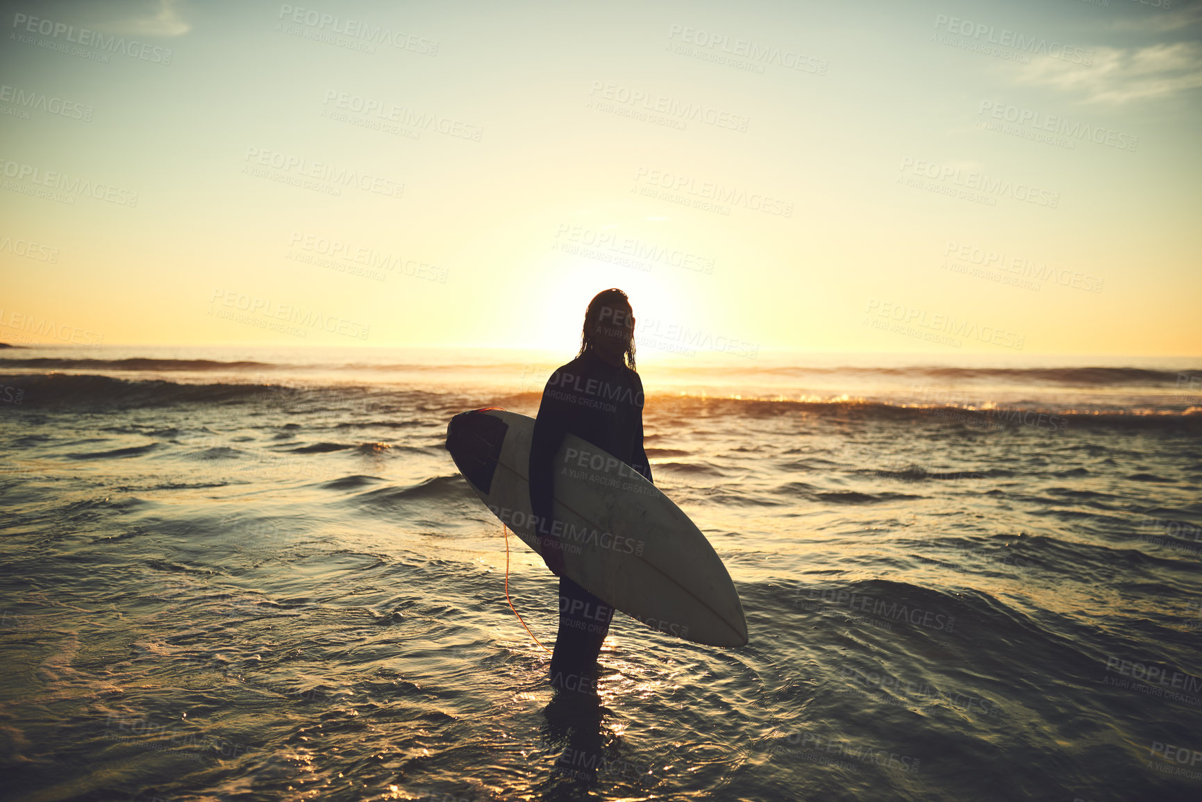 Buy stock photo Shot of a young man carrying a surfboard at the beach
