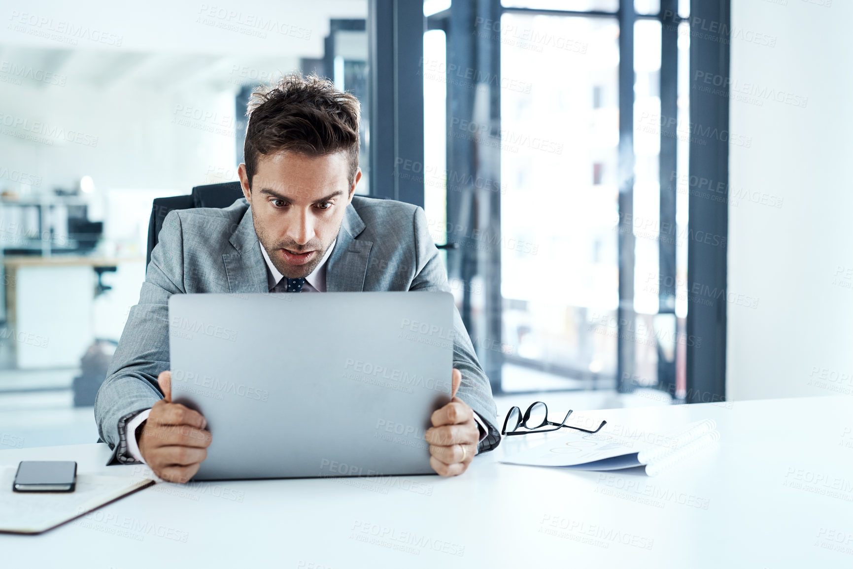 Buy stock photo Cropped shot of a businessman looking irritated with his laptop