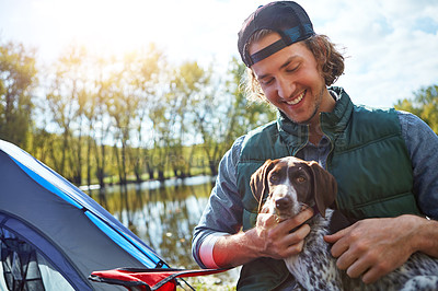 Buy stock photo Shot of a young man out camping with his dog
