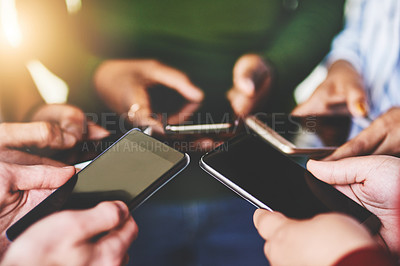 Buy stock photo Cropped shot of a group of people using their phones together