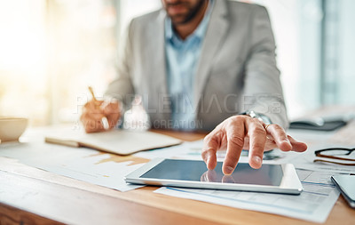 Buy stock photo Closeup shot of an unrecognizable businessman using a digital tablet in an office