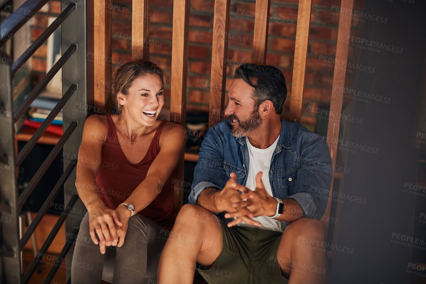 Buy stock photo Cropped shot of a middle aged couple having a good time while relaxing on the floor indoors