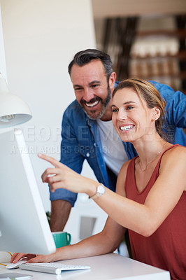 Buy stock photo Cropped shot of an attractive young woman having a discussion with her husband while sitting on a computer at home