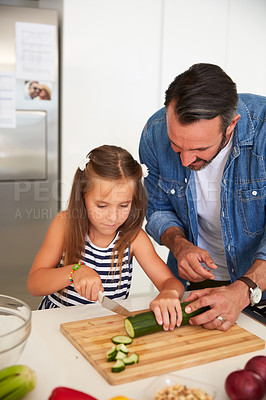 Buy stock photo Shot of an adorable little girl cooking with her father at home