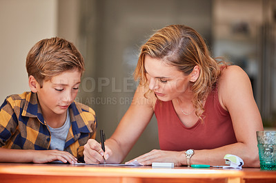 Buy stock photo Homework, helping and boy with mom for support, writing and guide in language test, knowledge or development. Happy mother, family and woman with child for education, teaching and learning at home