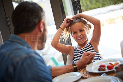 Buy stock photo Shot of an adorable little girl having a meal with her father at home