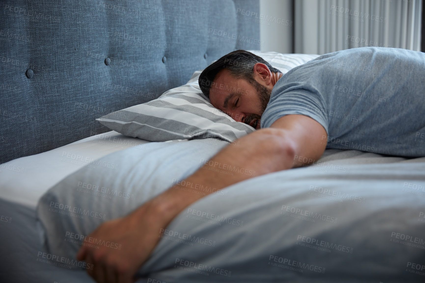 Buy stock photo Cropped shot of an attractive mature man fast asleep on his bed at home
