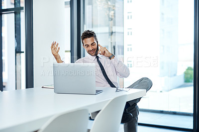 Buy stock photo Shot of a businessman talking on his cellphone while sitting at his desk