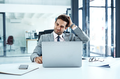 Buy stock photo Cropped shot of a businessman looking confused while sitting at his desk