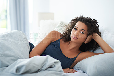 Buy stock photo Portrait of an attractive young woman laying seductively in bed in the morning