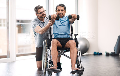 Buy stock photo Full length shot of a senior man in a wheelchair exercising with dumbbells along side his physiotherapist
