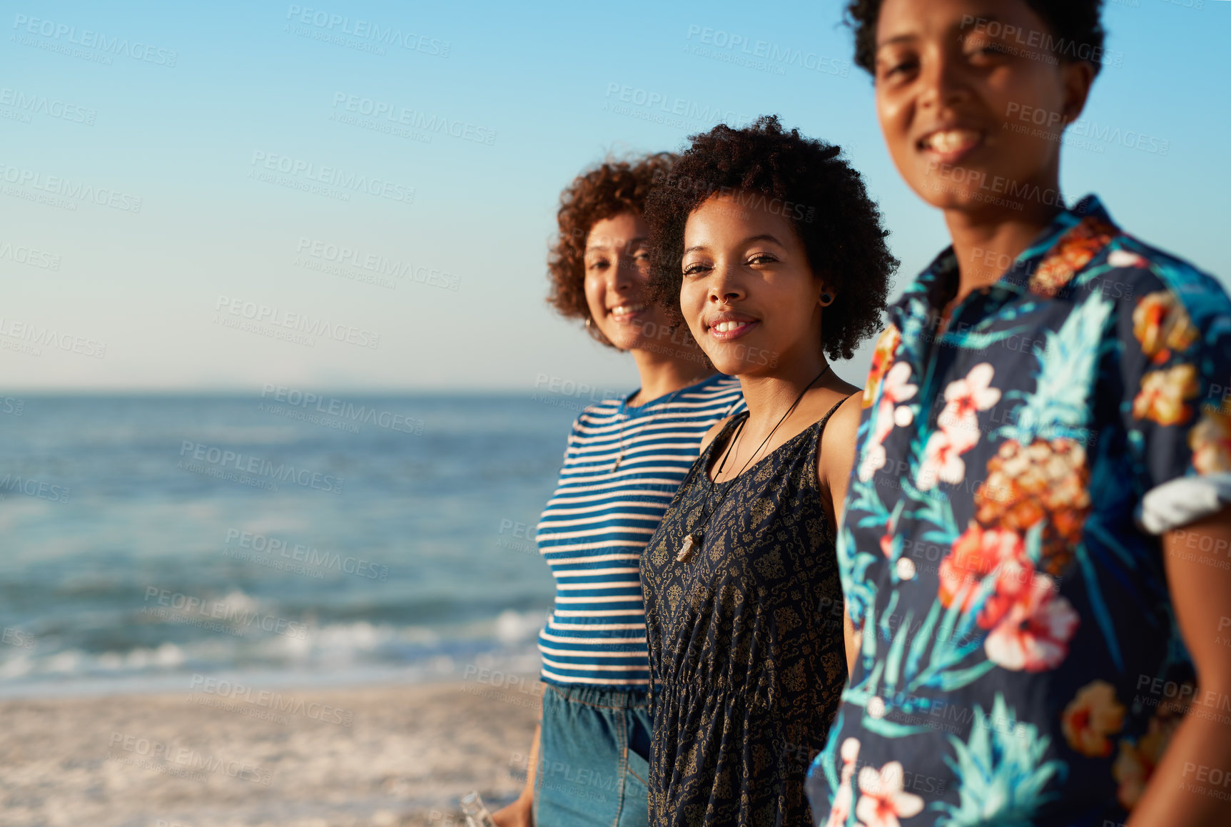 Buy stock photo Portrait of an attractive young trio of women standing together and posing on the beach during the day