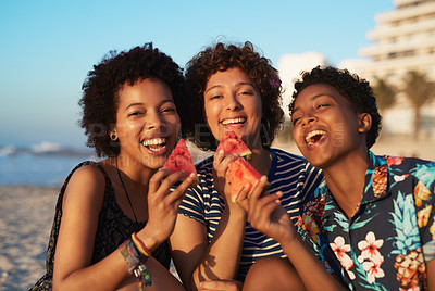 Buy stock photo Portrait of three attractive young women eating watermelon pieces on the beach during the day