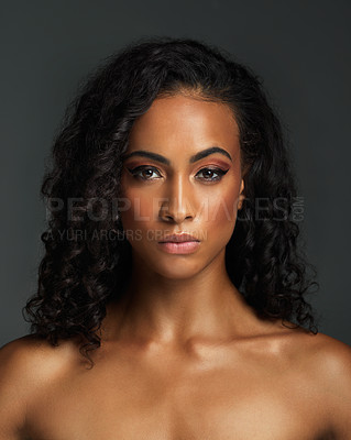 Buy stock photo Portrait of an attractive young woman posing alone shirtless and against a dark background in the studio
