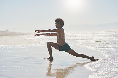 Buy stock photo Full length shot of a handsome young man dancing shirtless on the beach during the day