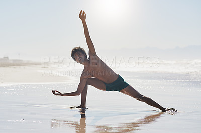 Buy stock photo Full length shot of a handsome young man dancing shirtless on the beach during the day