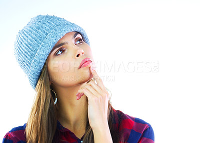 Buy stock photo Studio shot of a beautiful young woman looking thoughtful against a white background