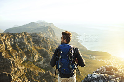 Buy stock photo Man, mountain and backpacking for outdoor exercise, travel and hiking in nature for tourism journey. Male person, trekking and athlete for sky mockup space, adventure and back for holiday workout