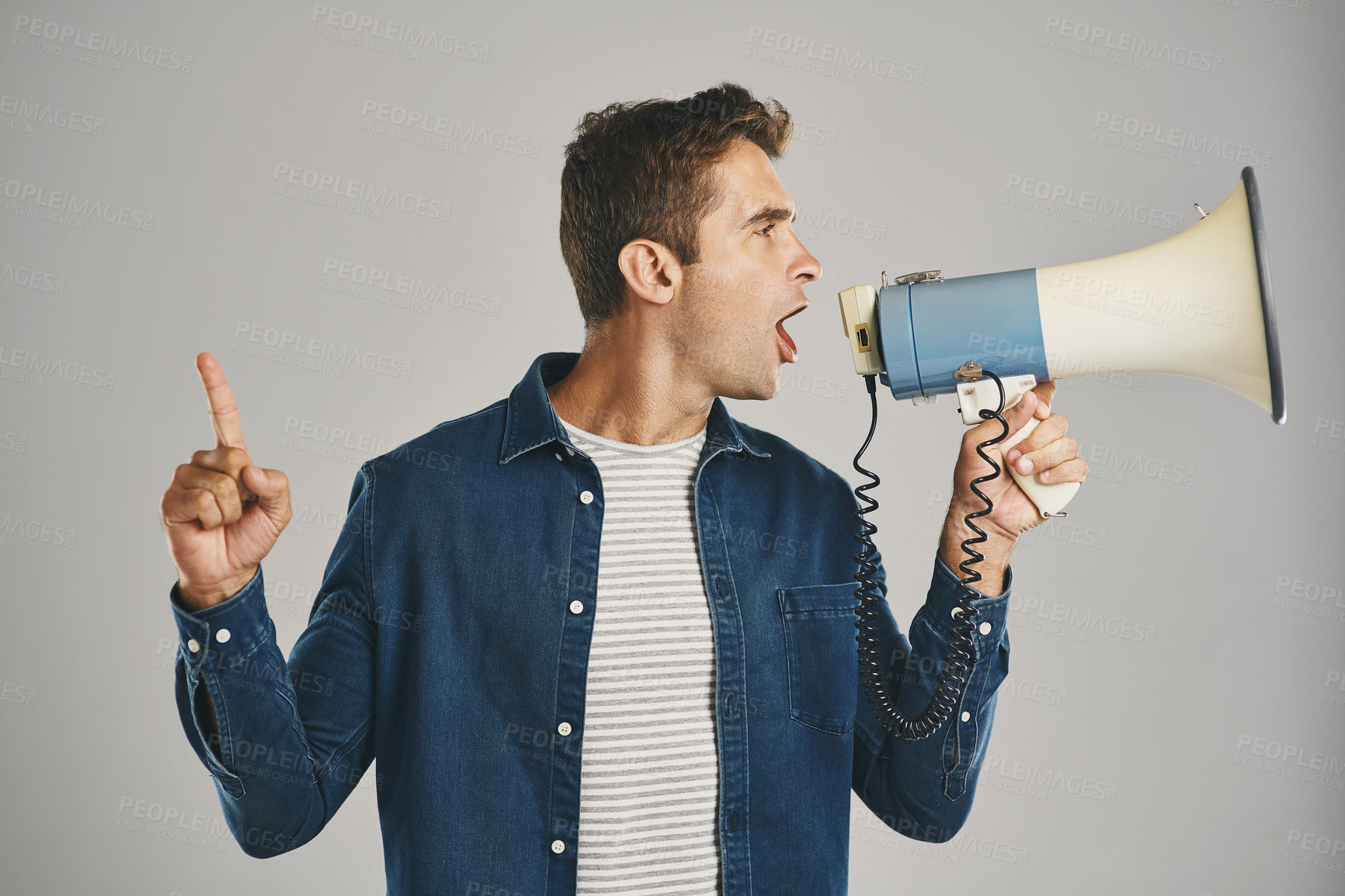 Buy stock photo Man, shout and megaphone for fight in studio of communication, community justice and warning protest. Person, microphone and attention with announcement, call to action and opinion on gray background