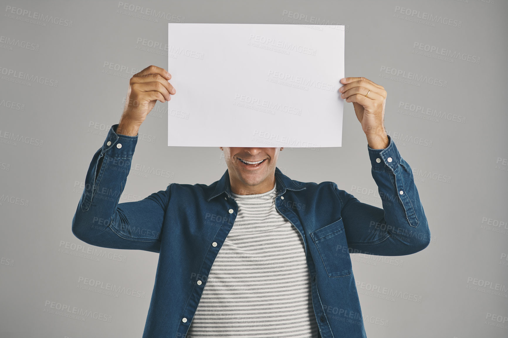 Buy stock photo Man, blank and happy with placard in studio for billboard announcement, presentation and branding logo. Male person, paper and advertising for news poster, signage and notification on gray background