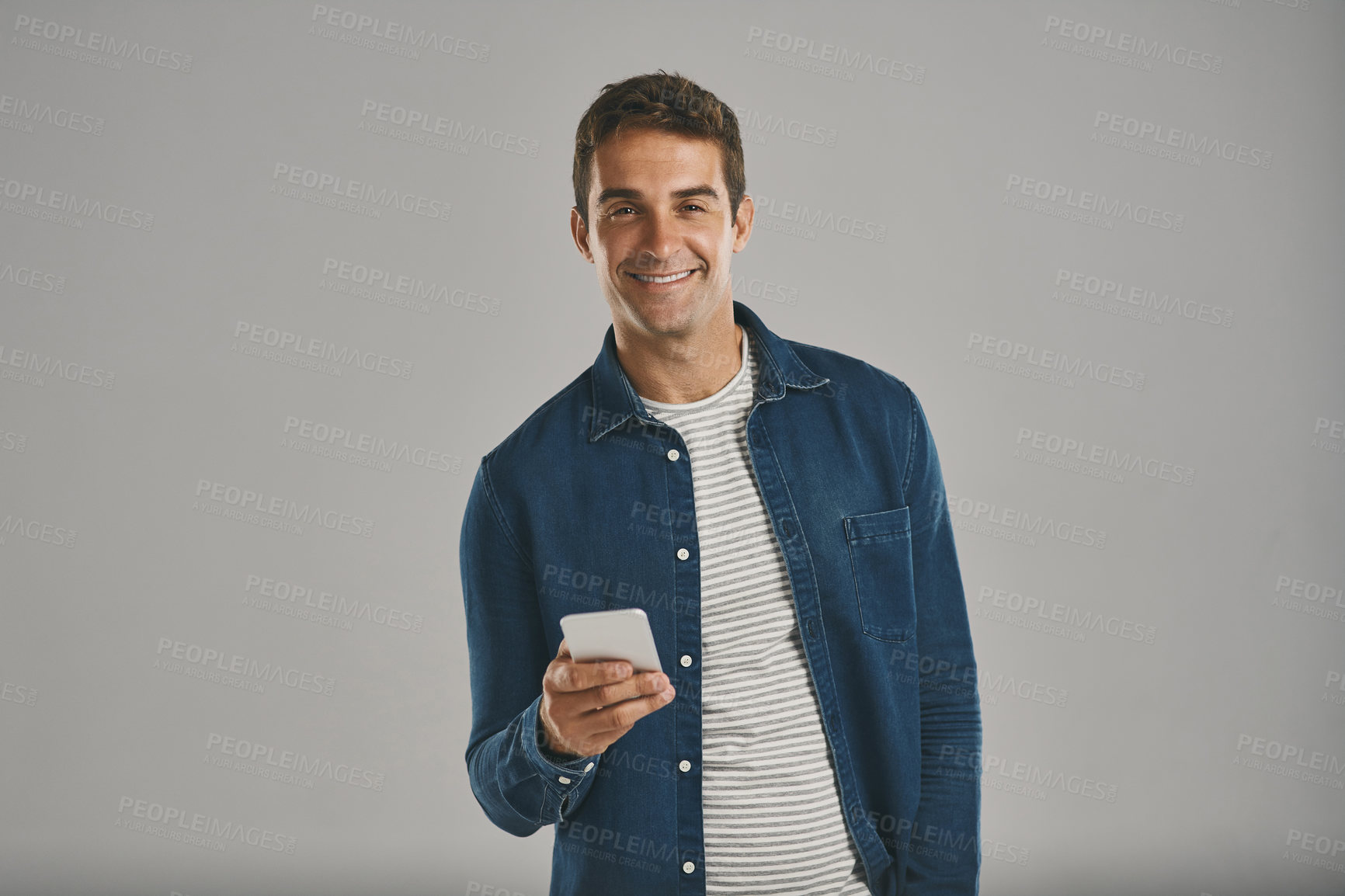 Buy stock photo Studio, man and portrait with mobile for laugh, funny news and comedy with contact by mockup. Creative worker, network and scroll on dating app with humor, chat and connection by white background