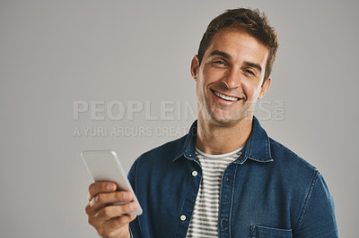 Buy stock photo Portrait, smile and man with smartphone, typing and internet with person on gray studio background. Face, guy and happy model with cellphone, social media or message to contact, texting or connection