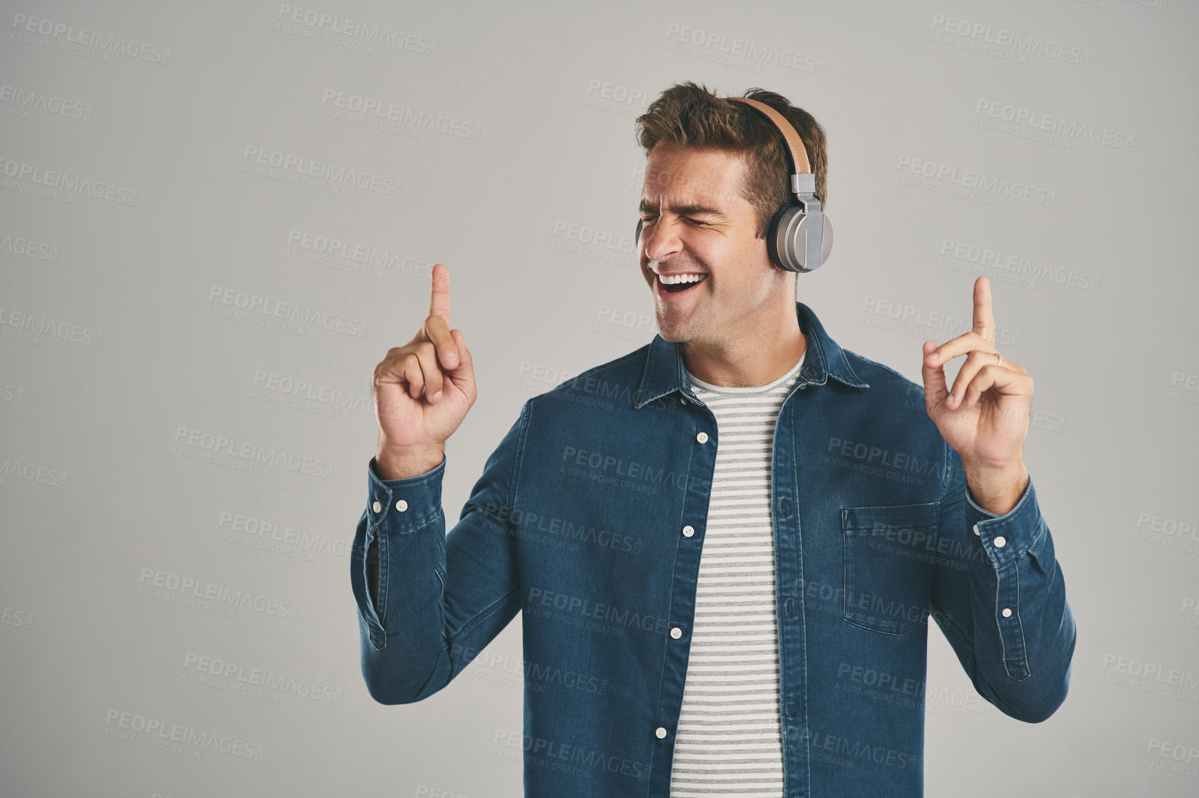 Buy stock photo Fun, music and man with headphones, studio and streaming of song, artist and relax with podcast. Mockup, happy and sound of radio, hearing and audio for person, app and online with subscription