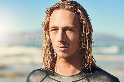 Buy stock photo Cropped shot of a handsome young man spending the day on the beach