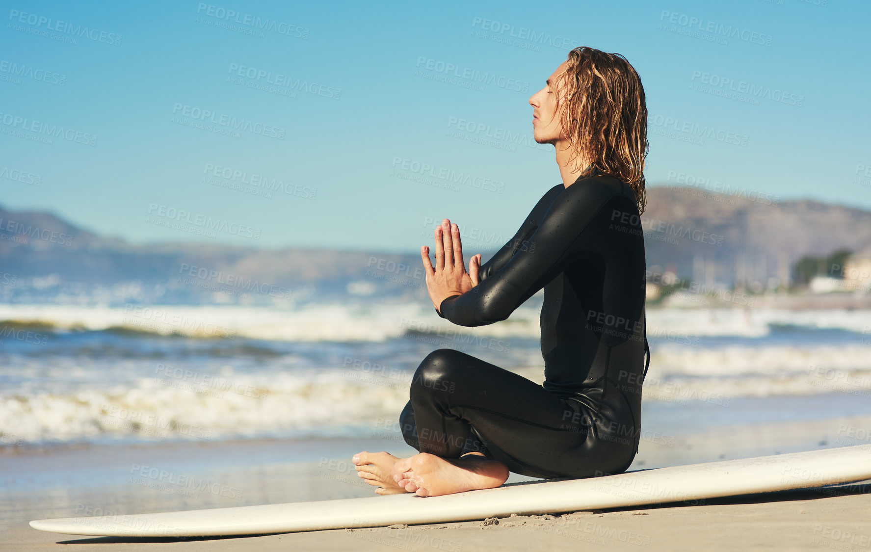 Buy stock photo Ocean, man and meditation on surfboard for summer adventure, travel vacation and zen aura. Surfer guy, peace and mental health by beach for surfing gear, prayer hands and calm holiday in Los Angeles