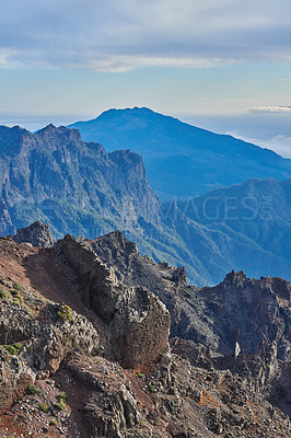 Buy stock photo Mountains, rocks and terrain on landscape, outdoor and sky on island with geology, trail and summer in environment. Cliff, stone and sunshine with hill, valley and path for tourism in La Palma, Spain