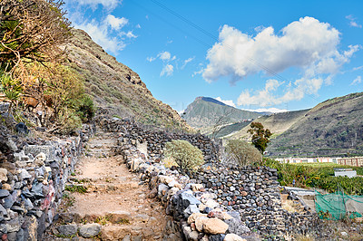 Buy stock photo Mountains, path and terrain on landscape, nature and sky on island with geology, rocks and summer in environment. Cliff, stone and sunshine with hill, valley and trail for tourism in La Palma, Spain