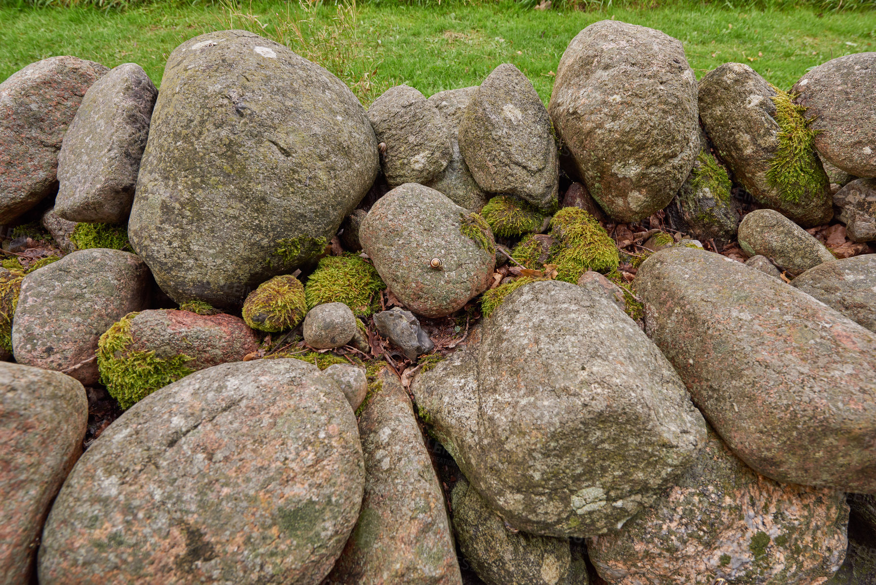 Buy stock photo Closeup of a stone wall made of boulders and rocks outside. Background of rustic, rural building and masonry material. Historic housing design or antique architecture of an urban structure outdoors