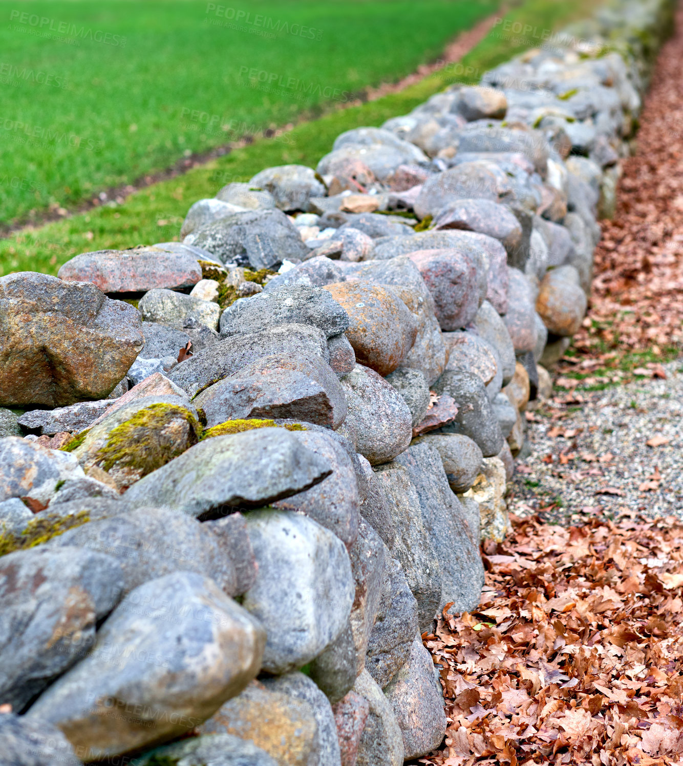 Buy stock photo Closeup of a stone wall made of boulders and rocks outside. Background of rustic, rural building and masonry material. Historic housing design or antique architecture of an old structure outdoors