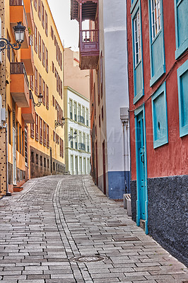 Buy stock photo Narrow cobbled street or alley between colorful buildings in Santa Cruz, de La Palma. Bright and classical architecture in a small city or village. Beautiful houses or homes with a vintage design