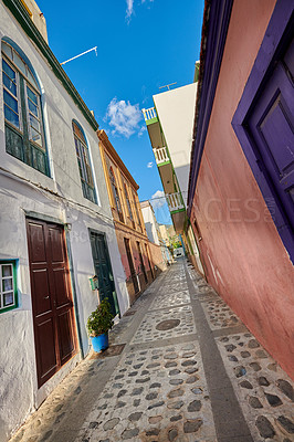 Buy stock photo Scenic city street view of old historic houses and traditional residential buildings in an alleyway road in summer. Tourism abroad and overseas travel destinations in Santa Cruz, La Palma in Spain