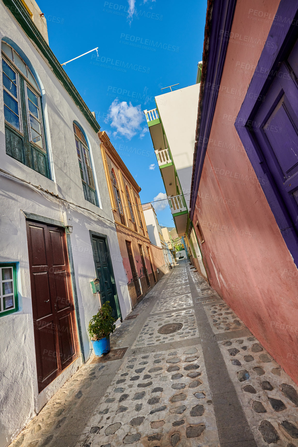 Buy stock photo Scenic city street view of old historic houses and traditional residential buildings in an alleyway road in summer. Tourism abroad and overseas travel destinations in Santa Cruz, La Palma in Spain