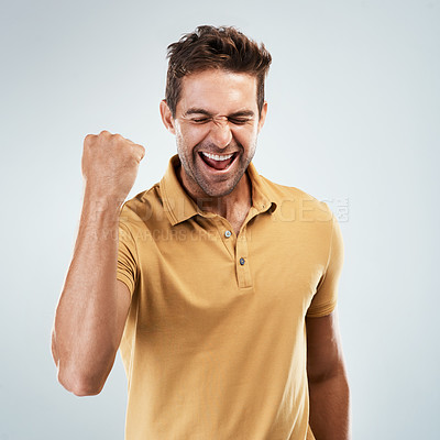 Buy stock photo Fist pump, smile and winner with reaction of man in studio on white background for bonus or success. Achievement, celebration and motivation with happy person cheering yes for goals or target