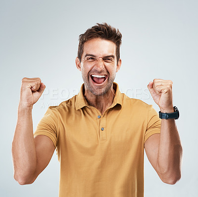 Buy stock photo Smile, target and winner with portrait of man in studio on white background for bonus or success. Achievement, celebration and motivation with fist of happy person cheering yes for profit or goal