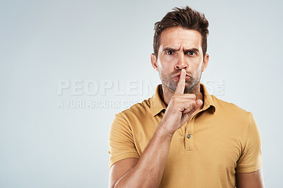 Buy stock photo Man, portrait and finger for mystery warning in studio, confidential privacy and white background. Male person, angry shush and emoji for quiet sign, stop talking gesture and icon on mockup space