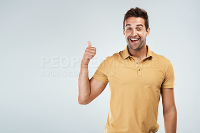 Buy stock photo Portrait of a young man with a excited facial expression while standing against a grey background